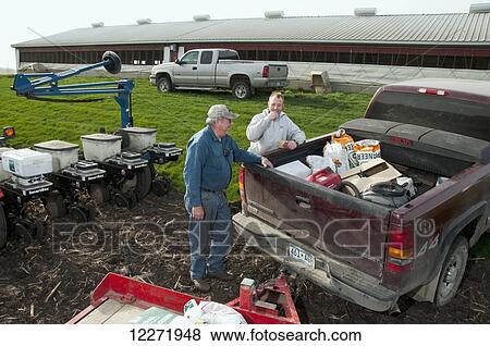 Father and son farmers preparing for spring planting of grain corn, near Northrop; Minnesota, United States of America View Large Photo Image Stock Photo - Father and son farmers preparing for spring planting of grain corn, near Northrop; Minnesota, United States of America. Fotosearch