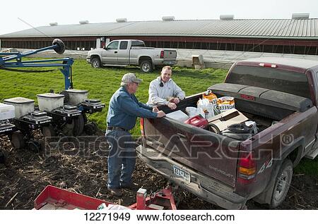 Stock Photo - Father and son farmers preparing for spring planting of grain corn, near Northrop; Minnesota, United States of America. Fotosearch