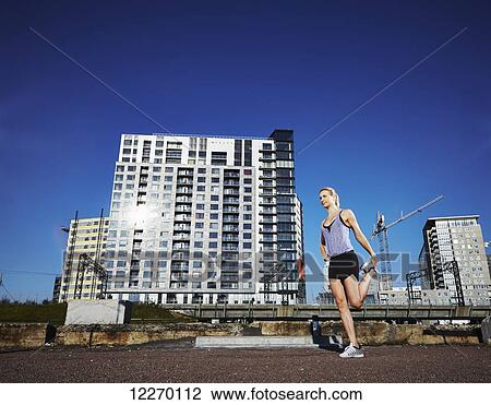 Female runner stretching before a run in an urban environment; Montreal, Quebec, Canada View Large Photo Image Stock Image - Female runner stretching before a run in an urban environment; Montreal, Quebec, Canada. Fotosearch