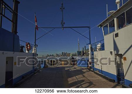 Stock Photograph - Ferry moving through ice in harbor waterfront; Toronto, Ontario, Canada. Fotosearch