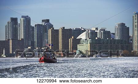 Fire rescue boat against city skyline from Ward's Island in winter; Toronto, Ontario, Canada View Large Photo Image Picture - Fire rescue boat against city skyline from Ward's Island in winter; Toronto, Ontario, Canada. Fotosearch