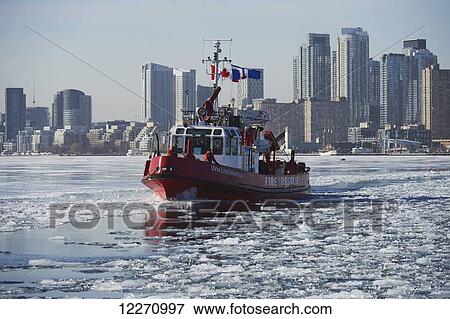 Fire rescue boat against city skyline from Ward's Island in winter; Toronto, Ontario, Canada View Large Photo Image Stock Photo - Fire rescue boat against city skyline from Ward's Island in winter; Toronto, Ontario, Canada. Fotosearch