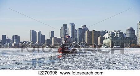 Fire rescue boat against city skyline from Ward's Island in winter; Toronto, Ontario, Canada View Large Photo Image Stock Photograph - Fire rescue boat against city skyline from Ward's Island in winter; Toronto, Ontario, Canada. Fotosearch
