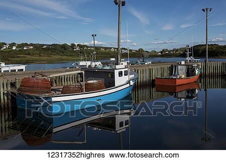 Stock Photograph - Fishing boats in the tranquil harbour; Mabou, Nova Scotia, Canada. Fotosearch