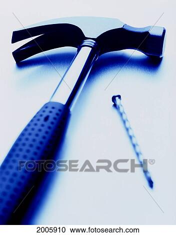 Stock Image - Fl6437, G. Biss Photography Ltd.; Hammer And Nail, Blue Toned. Fotosearch
