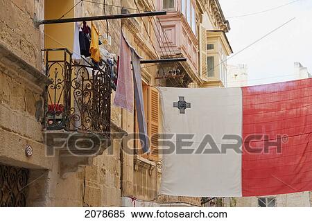Flag Of Malta Hanging Over A Street, Vittoriosa (Birgu), Malta View Large Photo Image Stock Photography - Flag Of Malta Hanging Over A Street, Vittoriosa (Birgu), Malta. Fotosearch