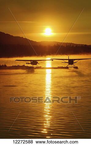 Stock Photo - Floatplanes silhouetted on Beluga Lake, Homer, Kenai Peninsula, Southcentral Alaska. Fotosearch