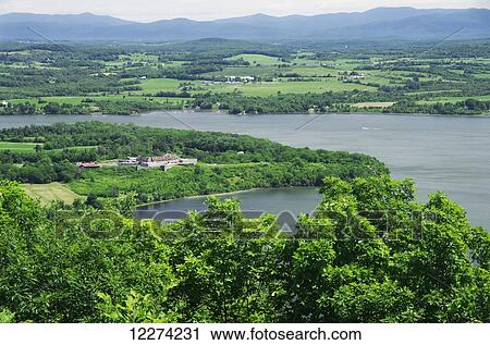 Stock Image - Fort Ticonderoga spreads out along edge of Lake Champlain, viewed from hillside; New York, United States of America. Fotosearch