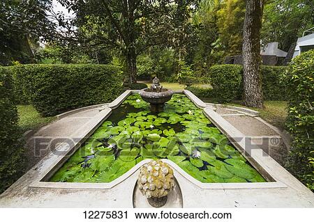Fountain in a pool with water lilies in the gardens of the Ullen Sentalu Museum, Central Java, Indonesia View Large Photo Image Stock Image - Fountain in a pool with water lilies in the gardens of the Ullen Sentalu Museum, Central Java, Indonesia. Fotosearch
