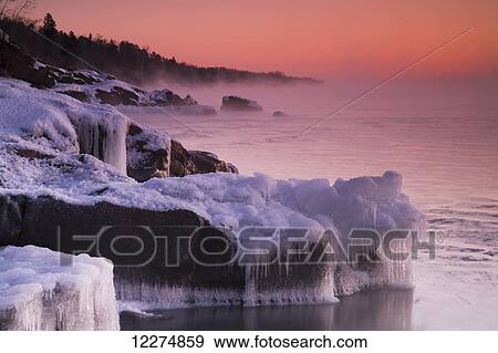 Frozen rocks along the North Shore of Lake Superior at sunrise; Duluth, Minnesota, United States of America View Large Photo Image Stock Photo - Frozen rocks along the North Shore of Lake Superior at sunrise; Duluth, Minnesota, United States of America. Fotosearch
