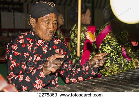 Gamelan orchestra accompanying the Wayang Kulit (shadow puppets) performance by a dalang (puppet master), Yogyakarta, Java Island, Indonesia View Large Photo Image Stock Image - Gamelan orchestra accompanying the Wayang Kulit (shadow puppets) performance by a dalang (puppet master), Yogyakarta, Java Island, Indonesia. Fotosearch