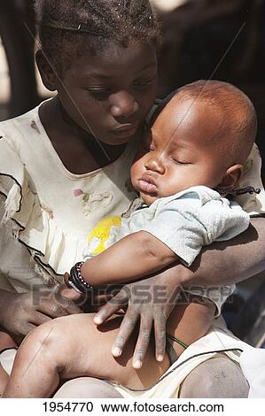 Girl and baby at the Monday Market, Djenne, Mali View Large Photo Image Stock Image - Girl and baby at the Monday Market, Djenne, Mali. Fotosearch