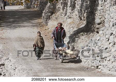 Girl And Man With A Wheelbarrow, Shigar, Northern Areas, Pakistan View Large Photo Image Stock Image - Girl And Man With A Wheelbarrow, Shigar, Northern Areas, Pakistan. Fotosearch