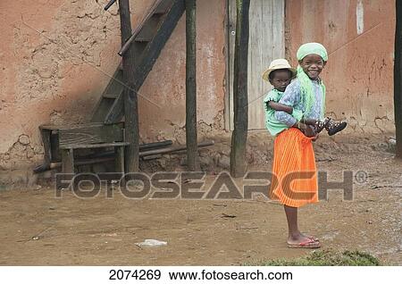 Girl Carrying A Boy In Ranomafana, Fianarantsoa Province, Madagascar View Large Photo Image Stock Photo - Girl Carrying A Boy In Ranomafana, Fianarantsoa Province, Madagascar. Fotosearch