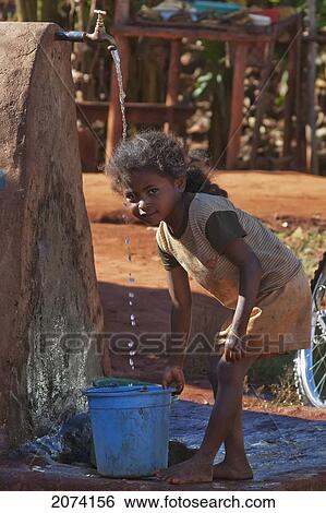 Stock Photograph - Girl Getting Water In Ambalavao, Fianarantsoa Province, Madagascar. Fotosearch