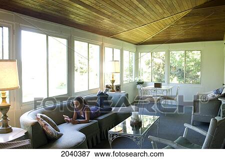Girl Reading In A Cottage Sun Room, Victoria Beach, Manitoba View Large Photo Image Stock Photo - Girl Reading In A Cottage Sun Room, Victoria Beach, Manitoba. Fotosearch