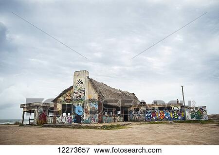 Stock Photo - Graffiti covering a building on the beach; Punta del Diablo, Uruguay. Fotosearch