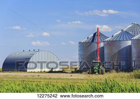 Stock Image - Grain silos and auger; Alberta, Canada. Fotosearch