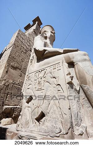Granite Colossus Of Ramses Ii On A Throne In Front Of The Entrance Pylon Of The Luxor Temple, Luxor, Qina, Egypt View Large Photo Image Stock Photograph - Granite Colossus Of Ramses Ii On A Throne In Front Of The Entrance Pylon Of The Luxor Temple, Luxor, Qina, Egypt. Fotosearch