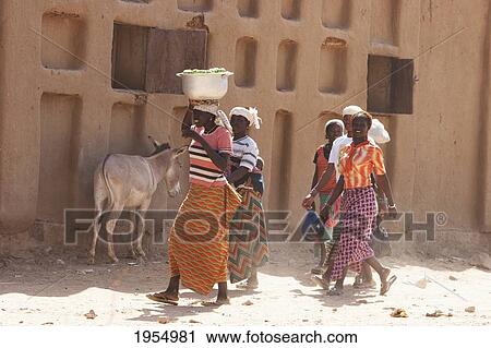 Group of women and donkey in front of built structure, Baniani, Mali View Large Photo Image Stock Image - Group of women and donkey in front of built structure, Baniani, Mali. Fotosearch