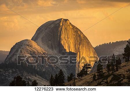 Stock Image - Half Dome at sunset during the Meadow Fire, as seen from near Olmsted Point along the Tioga Pass Road in Yosemite National Park; California, United States of America. Fotosearch