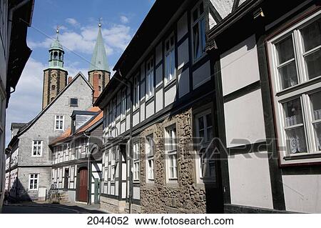 Stock Image - Half-Timbered Houses On Bergstrasse And Church Of Saints Cosmas And Damian, Goslar, Germany. Fotosearch