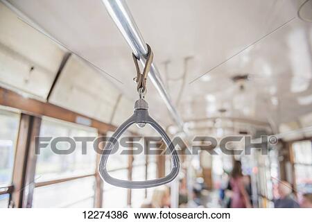 Handle hanging from bar in a tram; Milan, Lombardy, Italy View Large Photo Image Stock Photograph - Handle hanging from bar in a tram; Milan, Lombardy, Italy. Fotosearch