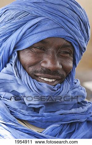 Stock Image - Happy mid-adult man in turban, Mali. Fotosearch