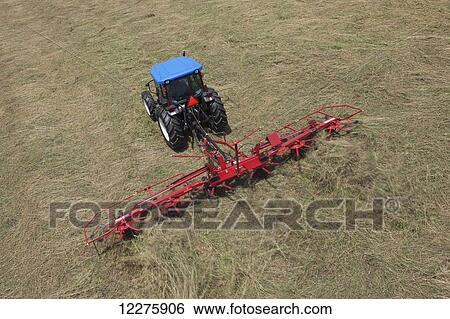 High angle view of New Holland T4050 tractor with H5270 tedder in alfalfa; New Holland, Pennsylvania, United States of America View Large Photo Image Stock Photograph - High angle view of New Holland T4050 tractor with H5270 tedder in alfalfa; New Holland, Pennsylvania, United States of America. Fotosearch