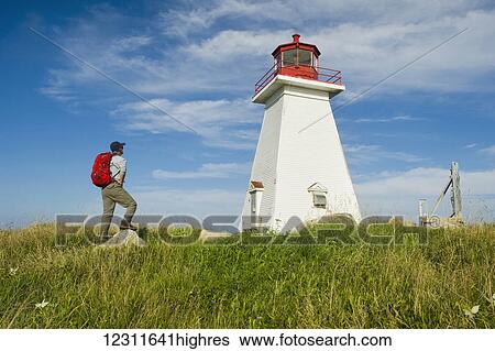 Hiker at Baccaro Point Lighthouse, Bay of Fundy; Nova Scotia, Canada View Large Photo Image Stock Photograph - Hiker at Baccaro Point Lighthouse, Bay of Fundy; Nova Scotia, Canada. Fotosearch