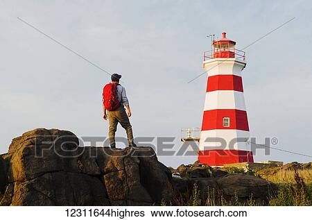 Hiker looking out over Brier Island Lighthouse, Brier Island, Bay of Fundy; Nova Scotia, Canada View Large Photo Image Stock Photograph - Hiker looking out over Brier Island Lighthouse, Brier Island, Bay of Fundy; Nova Scotia, Canada. Fotosearch