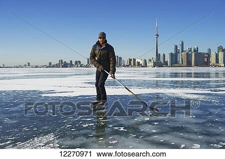 Hockey player and city skyline from Ward's Island; Toronto, Ontario, Canada View Large Photo Image Stock Image - Hockey player and city skyline from Ward's Island; Toronto, Ontario, Canada. Fotosearch