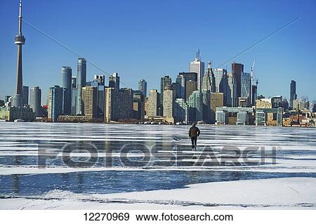 Hockey player and city skyline from Ward's Island; Toronto, Ontario, Canada View Large Photo Image Stock Photo - Hockey player and city skyline from Ward's Island; Toronto, Ontario, Canada. Fotosearch