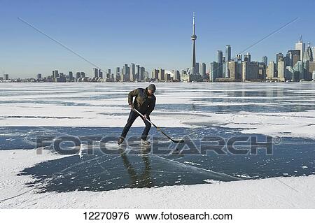Hockey player and city skyline from Ward's Island; Toronto, Ontario, Canada View Large Photo Image Stock Photograph - Hockey player and city skyline from Ward's Island; Toronto, Ontario, Canada. Fotosearch