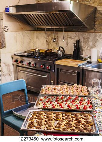 Hors d'oeuvres prepped for the oven in the kitchen of a large villa; Tuscany, Italy View Large Photo Image Stock Image - Hors d'oeuvres prepped for the oven in the kitchen of a large villa; Tuscany, Italy. Fotosearch