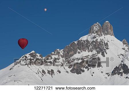 Hot air balloons floating high above snowy Bishop's Hat mountain peaks during the ski resort's annual hot air balloon festival; Filzmoos, Austria View Large Photo Image Stock Image - Hot air balloons floating high above snowy Bishop's Hat mountain peaks during the ski resort's annual hot air balloon festival; Filzmoos, Austria. Fotosearch