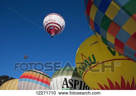 Stock Image - Hot air balloons readying for lift-off during the ski resort's annual hot air balloon festival; Filzmoos, Austria. Fotosearch