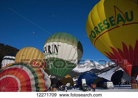 Hot air balloons readying for lift-off during the ski resort's annual hot air balloon festival; Filzmoos, Austria View Large Photo Image Stock Photo - Hot air balloons readying for lift-off during the ski resort's annual hot air balloon festival; Filzmoos, Austria. Fotosearch
