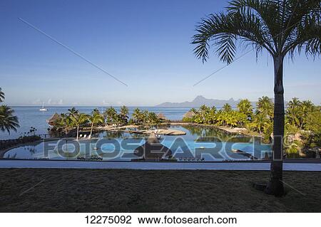 Stock Image - Hotel with pool and view of the ocean; Tahiti. Fotosearch