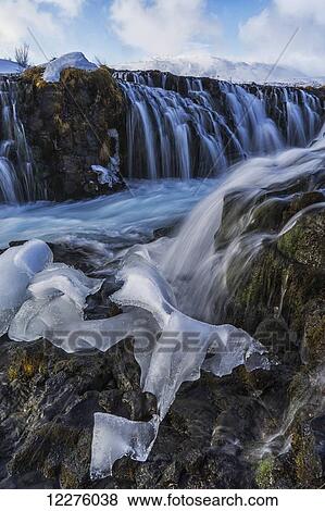 Stock Photo - Ice has been left behind after the Bruarfoss waterfall has melted; Iceland. Fotosearch