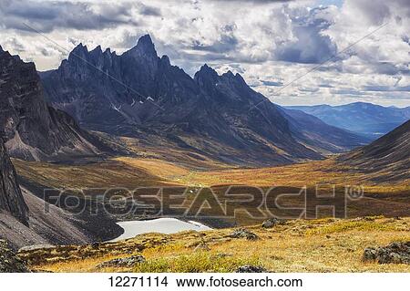 Picture - In the Yukon's North country, Tombstone mountain stands out above the tundra and surrrounding landscape; Yukon, Canada. Fotosearch