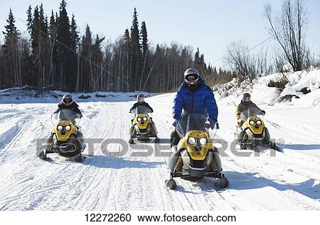 Iron Dog Adventure guide leads a snowmachine tour along the Chena River outside of Fairbanks in Interior Alaska View Large Photo Image Stock Image - Iron Dog Adventure guide leads a snowmachine tour along the Chena River outside of Fairbanks in Interior Alaska. Fotosearch