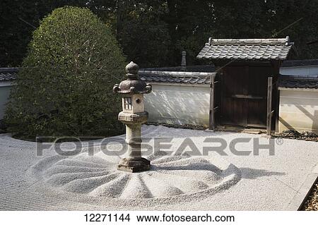 Picture - Japanese stone lantern in white gravel courtyard; Kyoto, Japan. Fotosearch