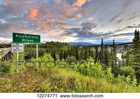 Stock Image - Kuskulana River sign at the Kuskulana River Bridge on the McCarthy Road in Wrangell-St. Elias National Park and Preserve, Southcentral Alaska, Spring, HDR. Fotosearch