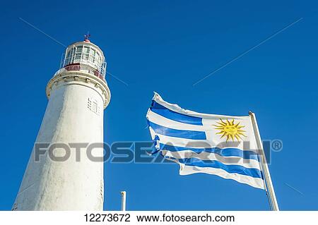 Stock Image - La Paloma lighthouse with flag; Uruguay. Fotosearch