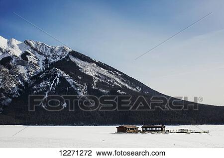 Lake Minnewanka and boathouse in winter in Banff National Park; Banff, Alberta, Canada View Large Photo Image Stock Image - Lake Minnewanka and boathouse in winter in Banff National Park; Banff, Alberta, Canada. Fotosearch