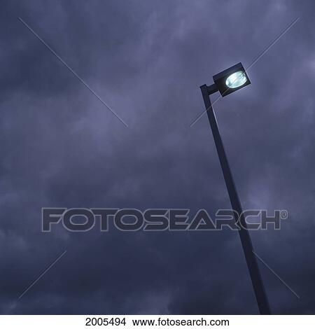 Picture - Lamp Post Against Cloudy Sky At Night. Fotosearch