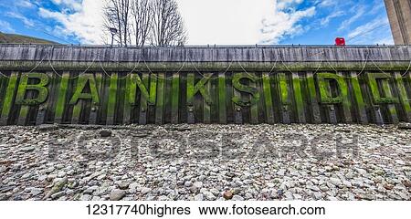 Stock Photograph - Large algae covered letters along the River Thames bank, Bankside; London, England. Fotosearch