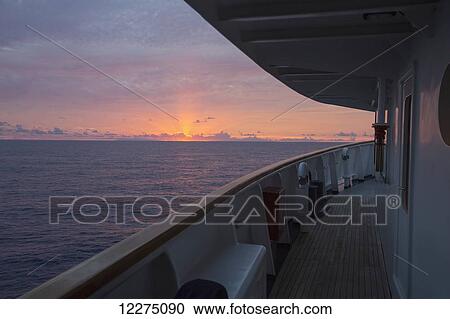 Stock Image - Large sports fishing boat at sunset; Tahiti. Fotosearch