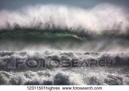 Stock Photograph - Large waves from the South Atlantic Ocean pound the shore of Cape Good Hope; South Africa. Fotosearch